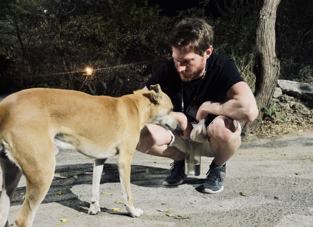 David Jackson feeding a stray dog in Santa Marta, Colombia